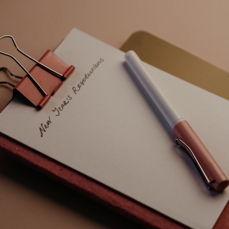 Red Notebook on the table to write your New year's resolutions